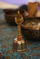 a bronze buddhist hand bell isolated over a white background photo