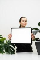 mock up of tablet in woman hand showing white blank empty screen photo
