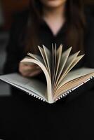 Artistic concept with open book pages on wooden surface, symbolizing literature and academia photo