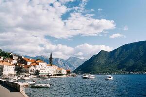 Many excursion boats with canopies are moored off the coast of Perast with views of the mountains. Montenegro photo