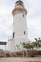White lighthouse and cloudy sky as a background photo