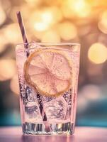 Refreshing Lemonade in a Sparkling Glass with Ice Cubes and Straw photo