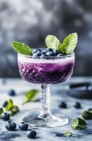 Refreshing Blueberry Cocktail with Mint Garnish in Elegant Glass photo