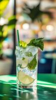 Refreshing Mint Mojito with Lime and Ice on a Vibrant Green Table photo