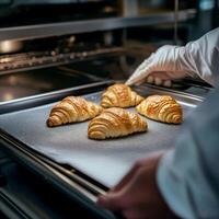 Freshly Baked Croissants in a Modern Oven Setting photo