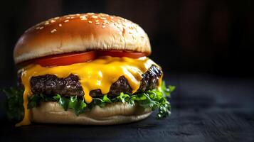Delicious cheeseburger with melted cheese, lettuce, and tomatoes on a dark background photo