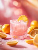 Refreshing Pink Lemonade Cocktail with Lemons and Ice in Bright Setting photo