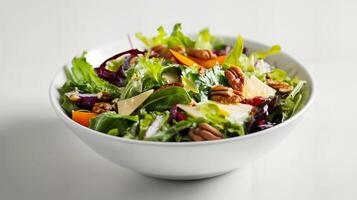 Colorful Green Salad with Nuts and Cheese in a White Bowl photo