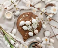 Elegant White Eggs Decorated with Spring Flowers on Wooden Surface photo