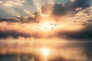 Breathtaking Sunset with Birds Soaring Over a Tranquil Waterscape photo