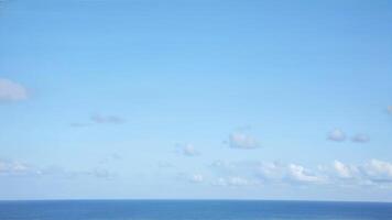 Tranquil Ocean View Under a Clear Blue Sky with Soft Clouds photo