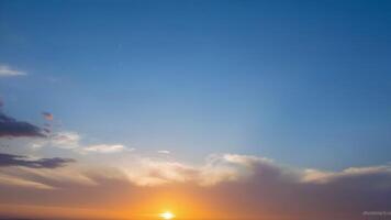 Beautiful Sunset Over Horizon with Soft Clouds and Clear Sky photo