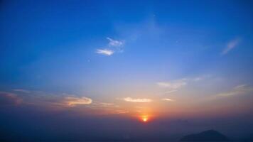 Breathtaking Sunset Over Distant Mountains with Vibrant Sky photo