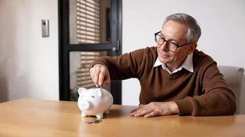 Man Saving Money in a Piggy Bank at Home photo