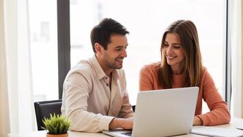 Engaging colleagues collaborating with a laptop in a modern workspace photo