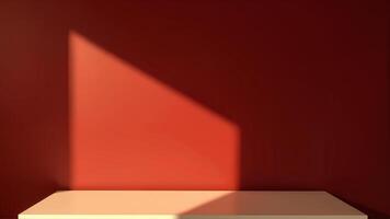 Soft Shadow on Warm Red Wall with Light Neutral Surface Below photo