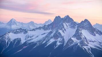 Majestic Mountain Ranges Under a Soft Pastel Sky at Dusk photo