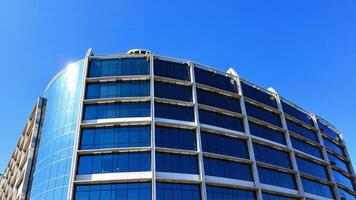 Modern Architectural Design with Glass Facade against Clear Blue Sky photo