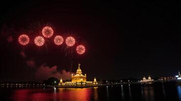 Spectacular Fireworks Display Over Illuminated Temples Reflecting in Water photo