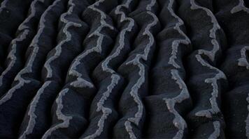 Textured Patterns in Dark Material with Wavy Lines photo