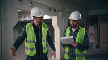 Angry nervous foreman inspector showing hand watch time worker employee late build deadline two Caucasian men males workers guys engineers contractors builders problem loss construction project plan video