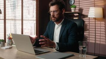 Stressed overworked Caucasian businessman burnout aggressive angry guy male irritated annoyed business man yelling screaming typing laptop computer work problem shouting looking at camera in office video