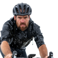 Intense Cyclist in Rain Gear Riding Through Wet Conditions with Focus and Determination png