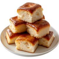 Deliciously Soft Cake Squares Piled on a White Plate with Golden Glaze Finish and Moist Texture png