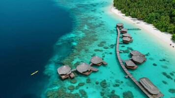 An aerial view of a tropical island with overwater bungalows video