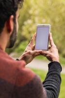 Anonymous man browsing on mobile phone on terrace photo