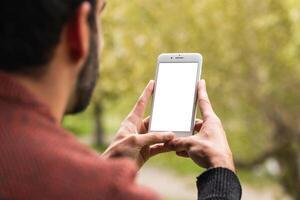 Anonymous man browsing on mobile phone on terrace photo