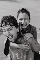 Happy boy in piggyback ride over back of brother photo