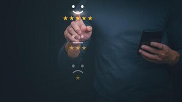 a man is holding a smartphone with five stars on it photo