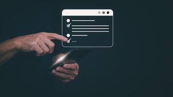 man holding smartphone with checklist on dark background photo