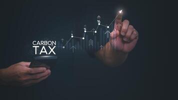 carbon tax concept with man holding smartphone and pointing to graph photo