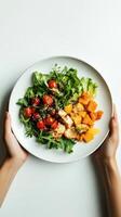 A healthy salad with chicken and roasted vegetables on a plate photo