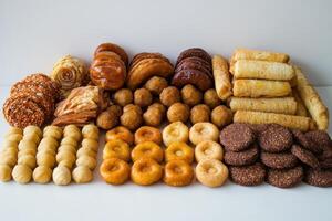 Assorted sweet pastries and baked goods arranged on a white surface photo