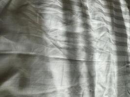 Fabric with subtle texture and light pattern in a neutral shade on a flat surface photo
