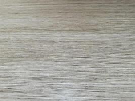 Textured wooden surface showing natural grain patterns and subtle color variations photo