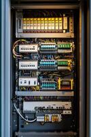 Open electrical cabinet displaying complex wiring and components photo