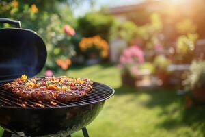 Grilling sausages and vegetables on a barbecue in a garden during a sunny summer day photo
