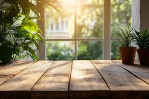 Empty wooden table illuminating by sunlight coming from window with plants photo
