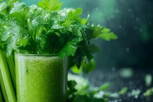 Fresh celery juice with sprig of celery and water drops on dark background photo