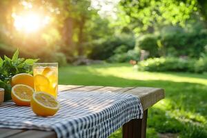 Refreshing lemonade with ice and mint on wooden table in summer garden at sunset photo