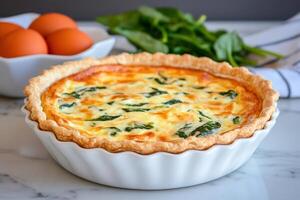 Delicious spinach quiche with fresh spinach and eggs baking on marble table photo
