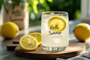 Refreshing lemonade with ice and lemon slice saying hello summer photo