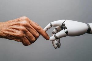 Senior citizen hand touching robotic hand symbolizing connection photo