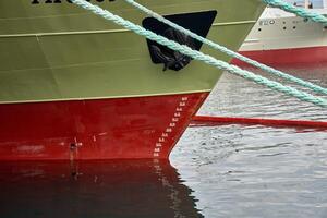 Close-up of the bow with draft and waterline scale of a fishing boat photo