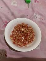 pomegranate seeds on white plate photo