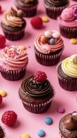 Many cupcakes with frosting on pink background photo